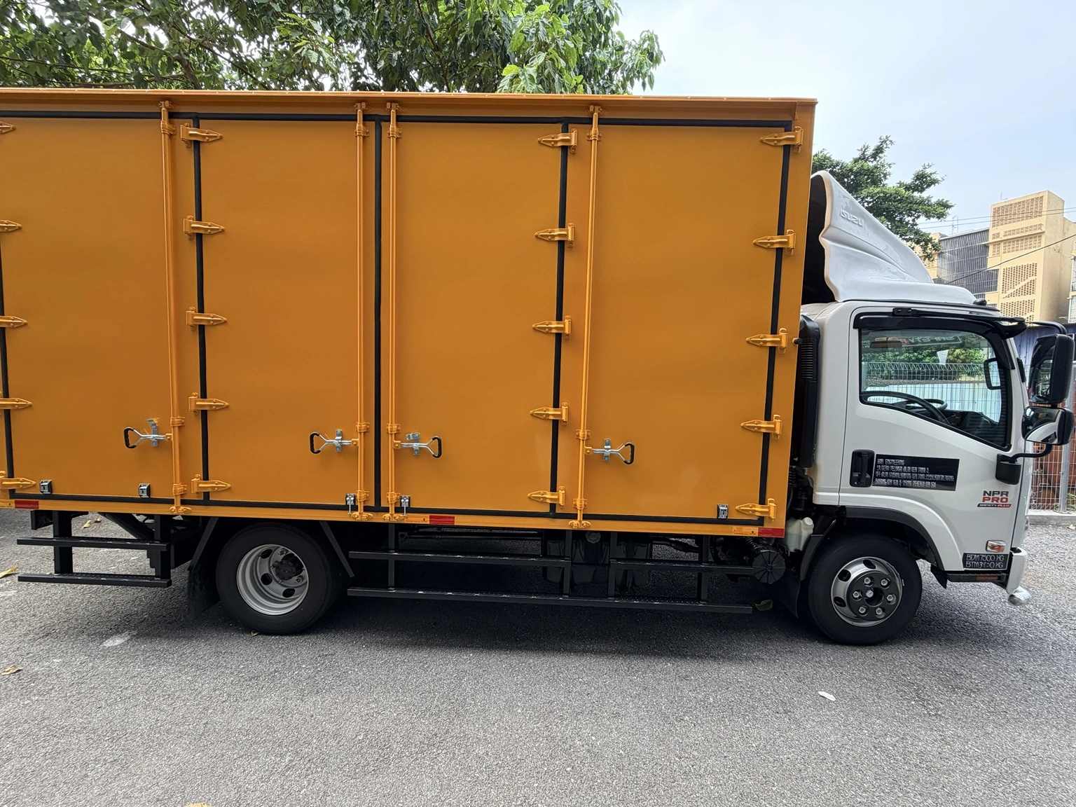 Isuzu lorry with a box body and tail lift