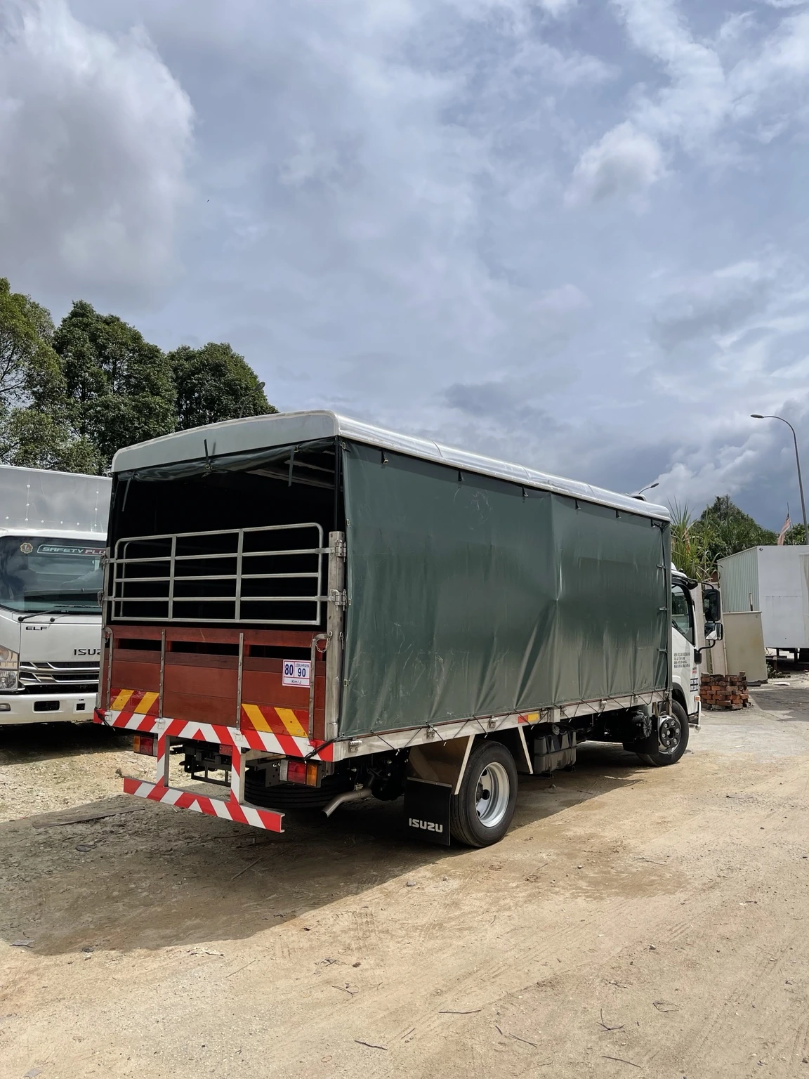 Isuzu lorry with a covered canvas cargo body