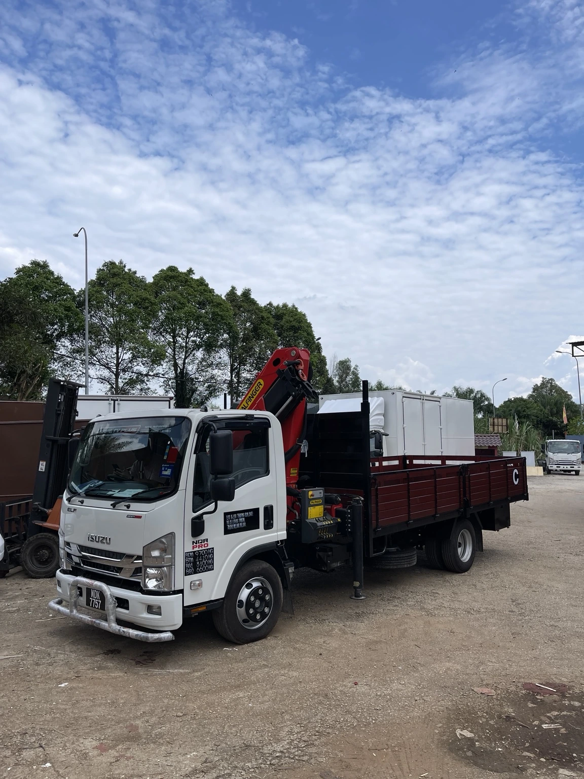 Isuzu crane truck with an open cargo body