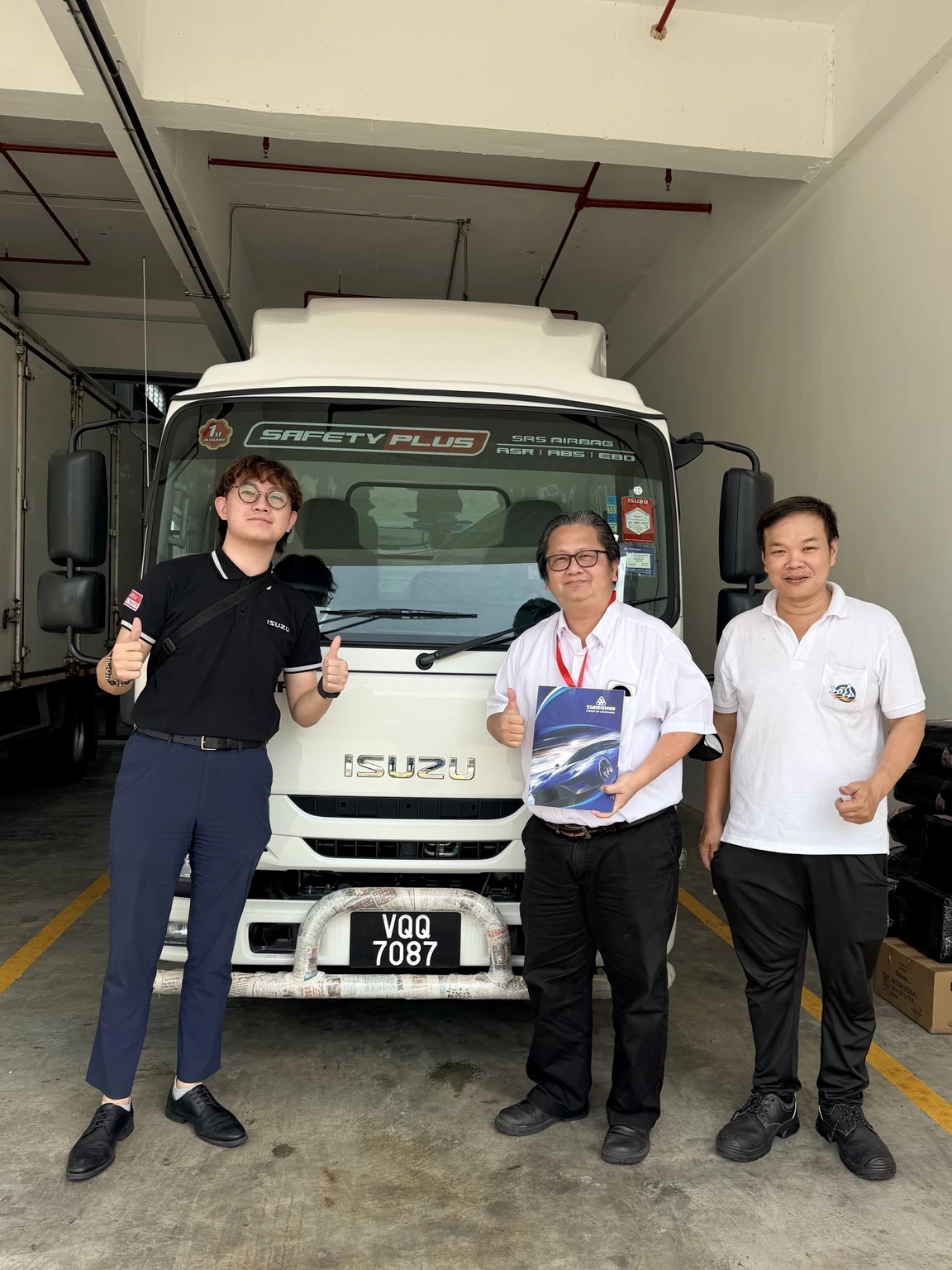 Adam with customers at an Isuzu lorry handover