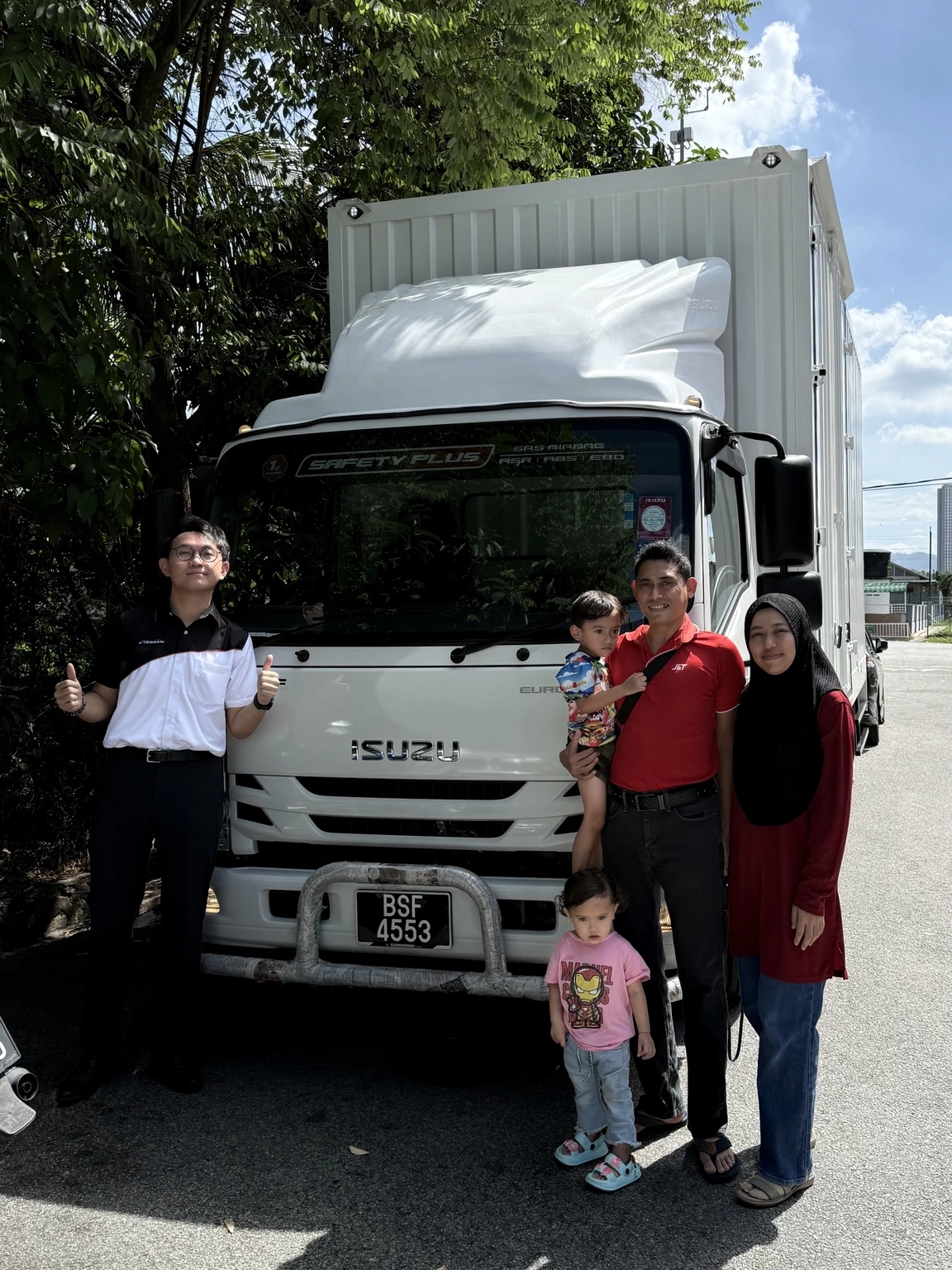 Family receiving their Isuzu lorry